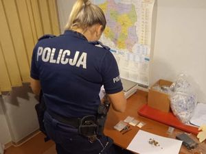 Policjantka stoi tyłem i wykonuje test narkotestem